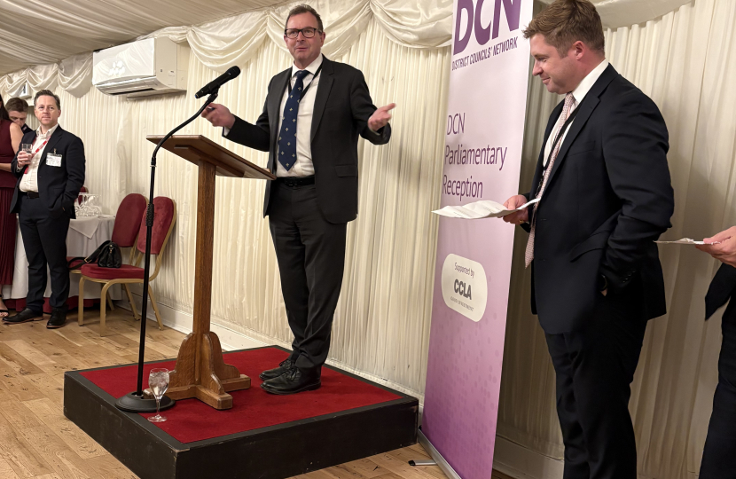 Lord Fuller speaking, watched by retiring DCN chairman Sam Chapman-Allen