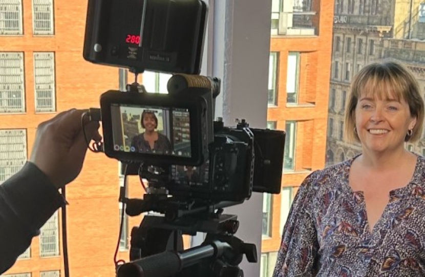 Stock photo of Abi speaking to camera