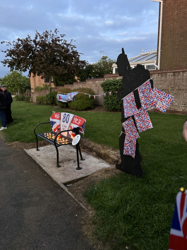 The memorial bench and soldier silhouette adorned for VE Day