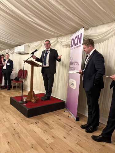 Lord Fuller speaking, watched by retiring DCN chairman Sam Chapman-Allen