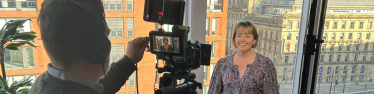 Stock photo of Abi speaking to camera